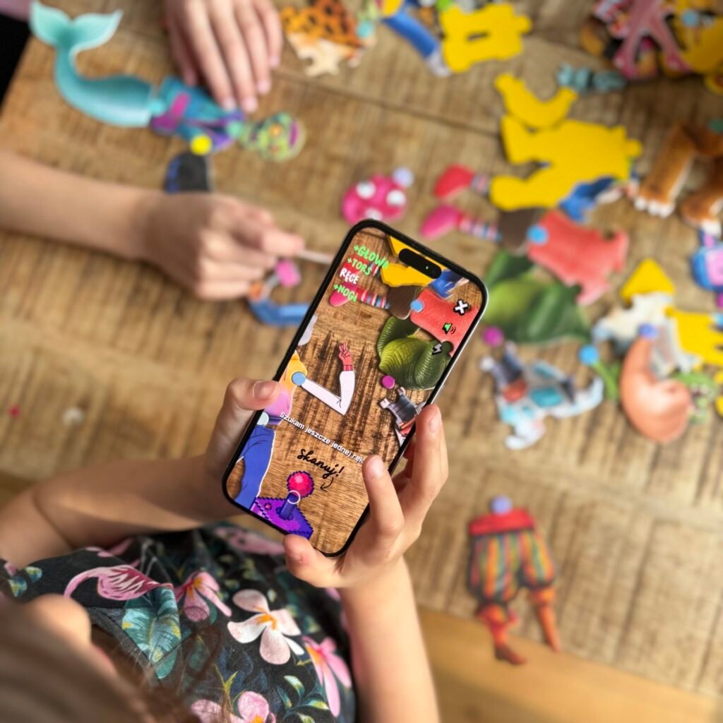 Dziewczynka trzyma element MUTABOX z głową kota i reaguje z radością